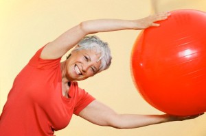 Senior woman practicing with gymnastic ball